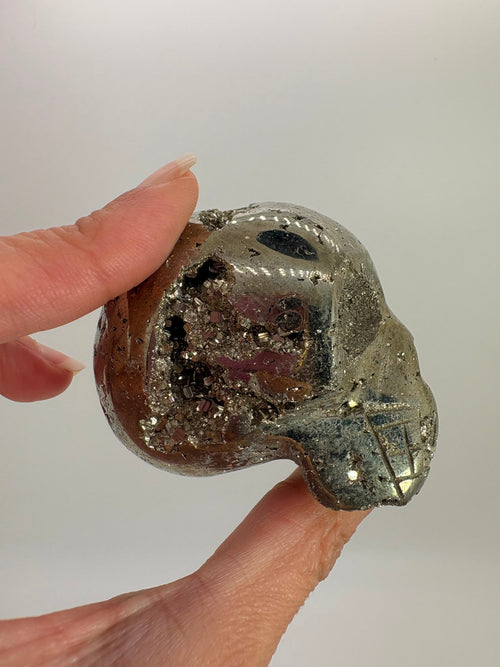 Calavera de pirita natural con drusa de cristales. Pieza única de 6 × 4,5 cm, ideal para colección, decoración y amantes de los minerales naturales.