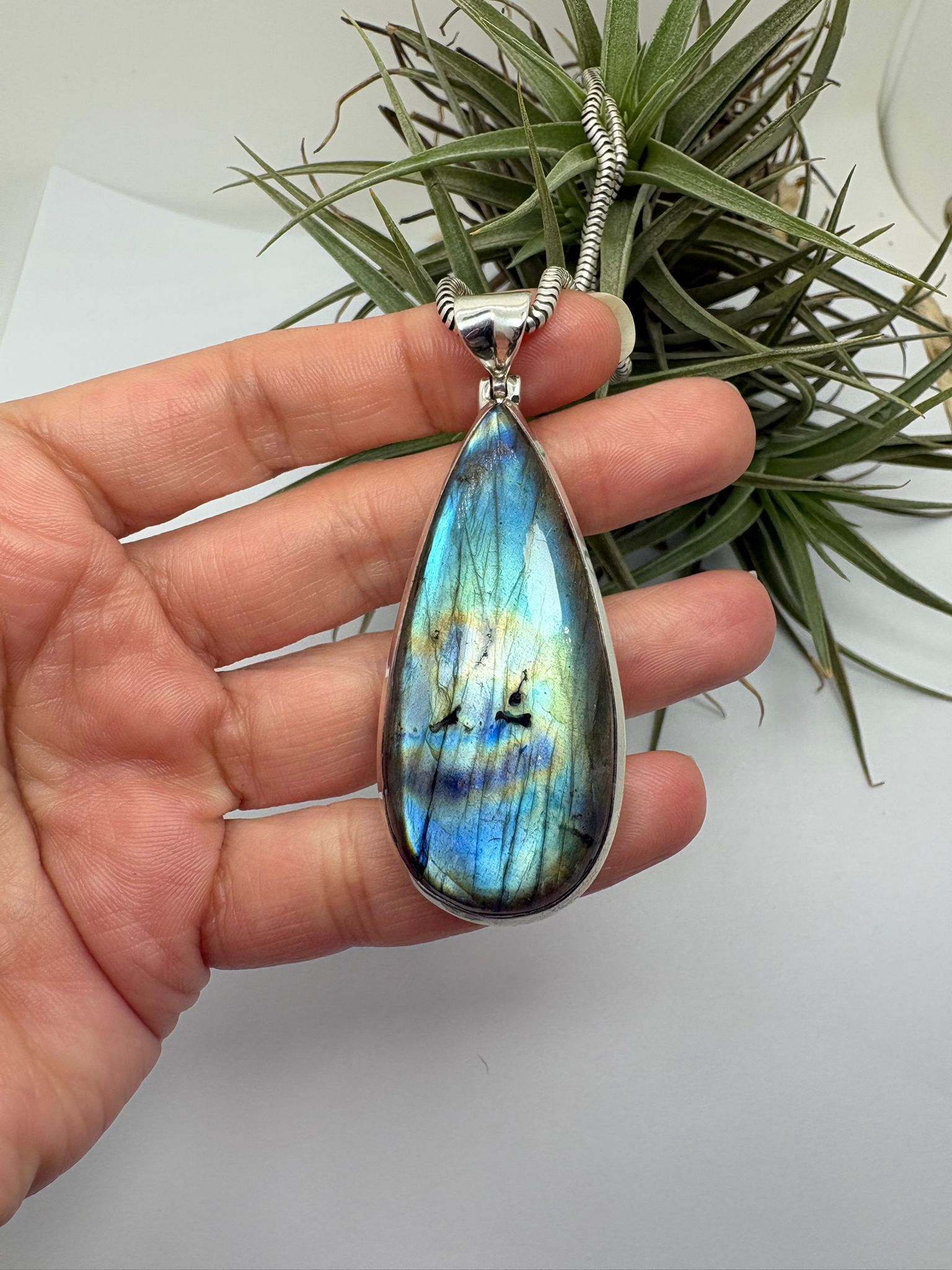 Colgante de labradorita en plata de ley con reflejos iridiscentes. Piedra natural única con tonos azules y verdes. Joya elegante y con carácter.Piedra espiritual de cambio y evolución.