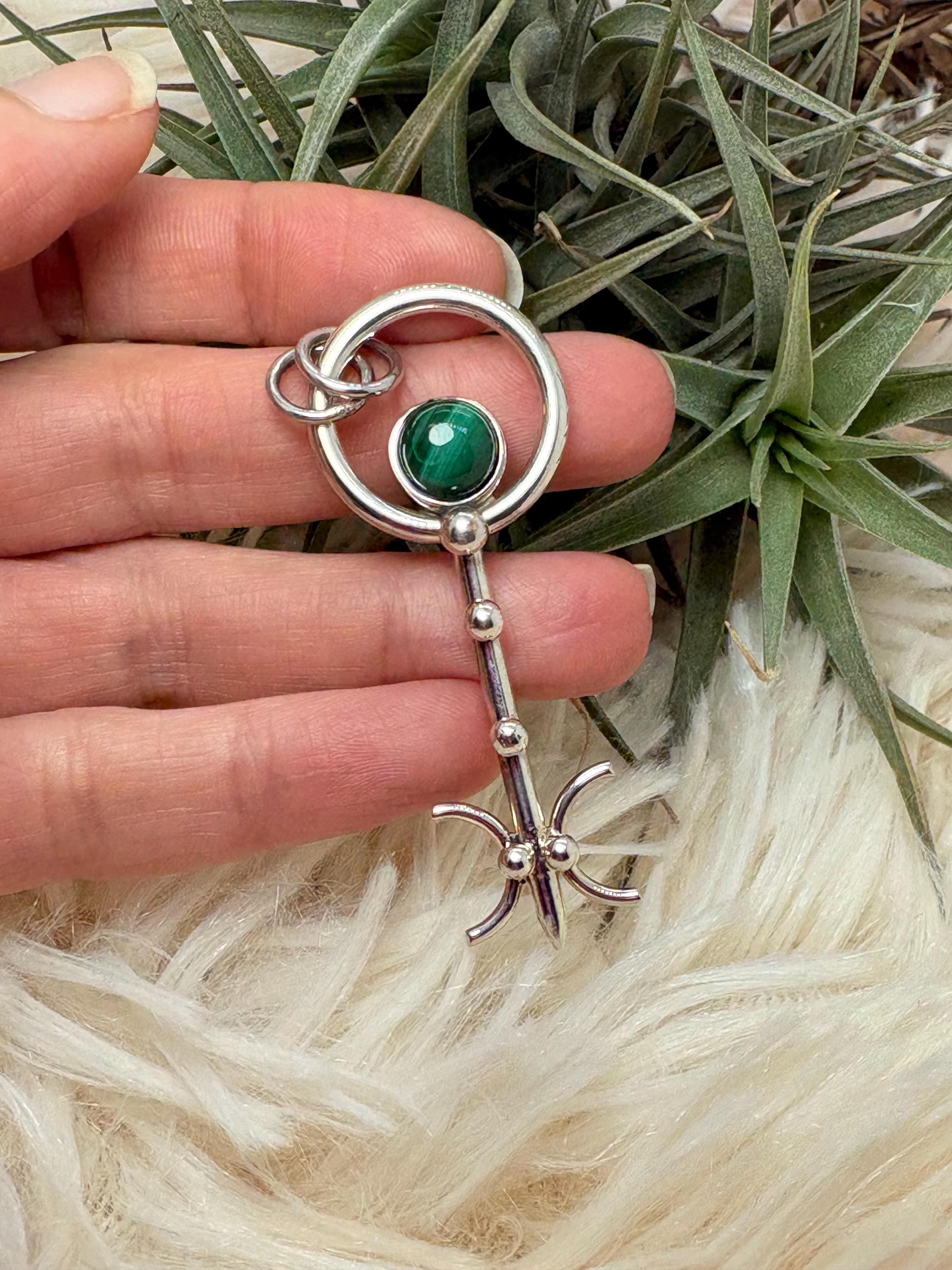 Colgante llave de malaquita en plata de ley artesanal. Joya con significado que abre caminos y favorece la transformación personal.