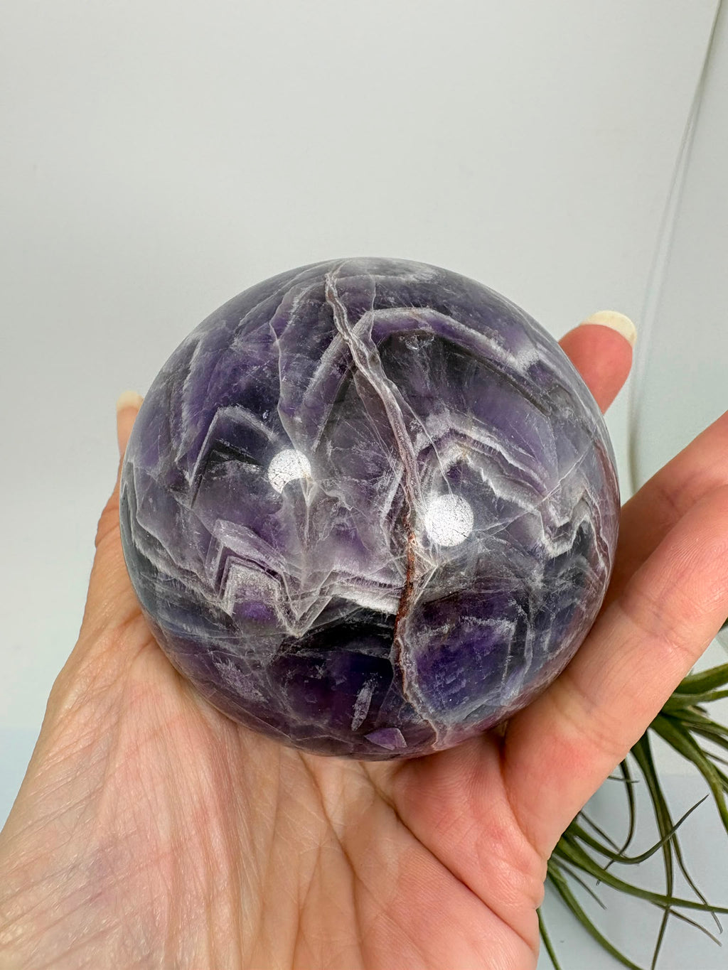 Esfera de amatista africana natural de 6,9 cm. Pieza única de intensos tonos violetas, ideal para colección, decoración, meditación y armonización de espacios. La base no está incluida.