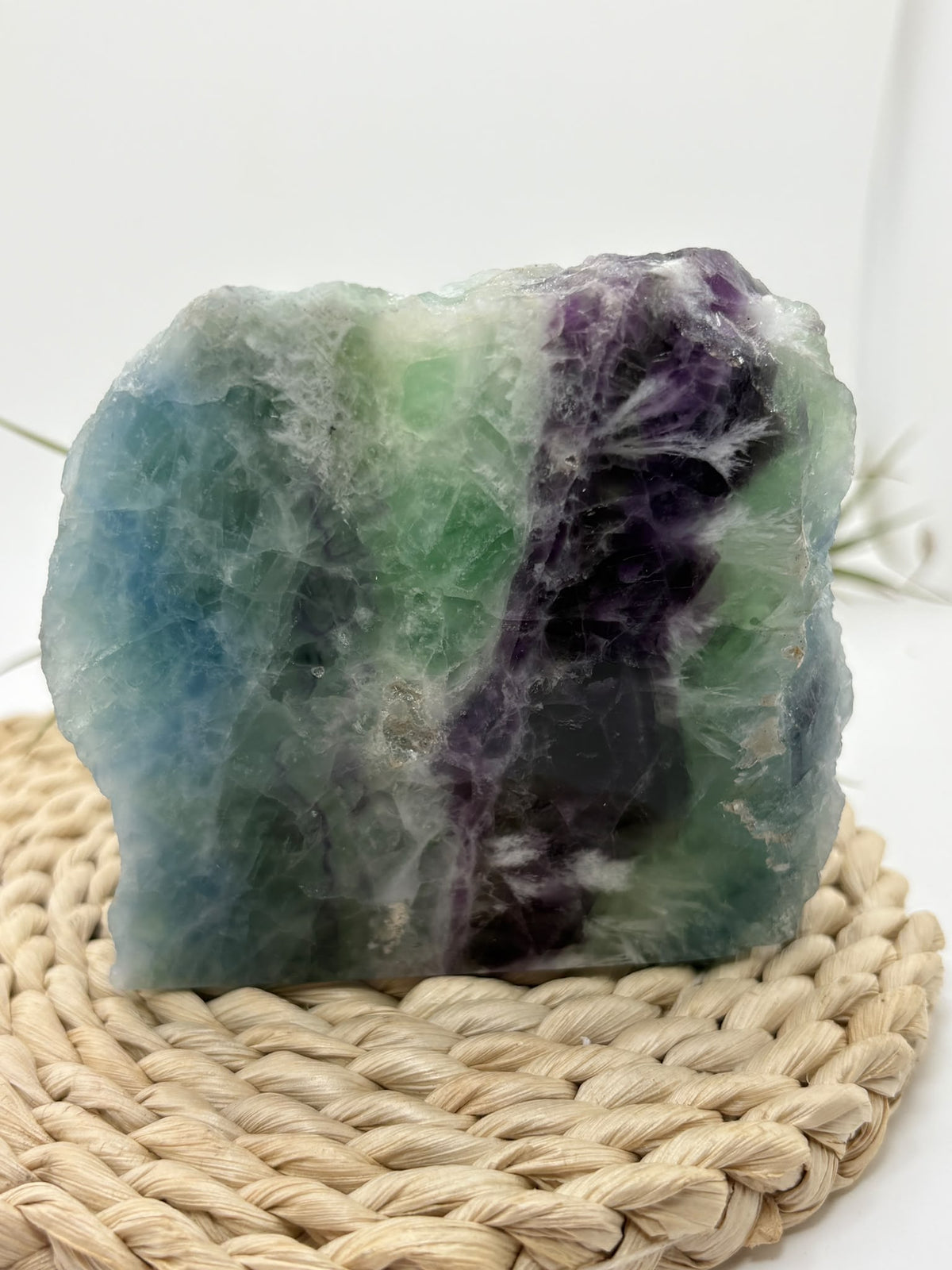 Fluorita arcoíris natural de cara pulida en tonos verdes, azules y violetas.