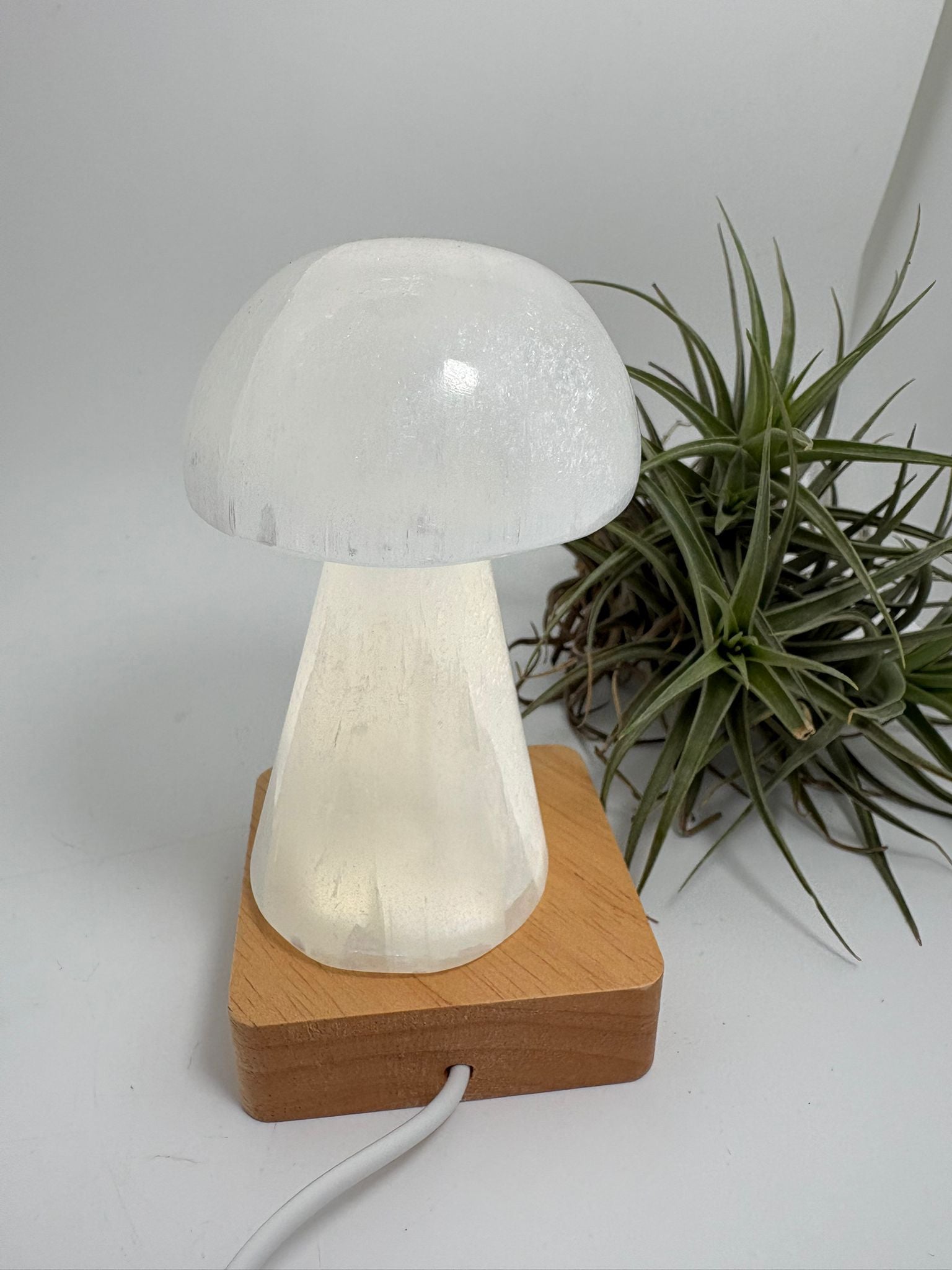 Lámpara usb de selenita natural con base led de madera. Pieza de gran calidad, elegante y luminosa, ideal para decorar y armonizar cualquier espacio.