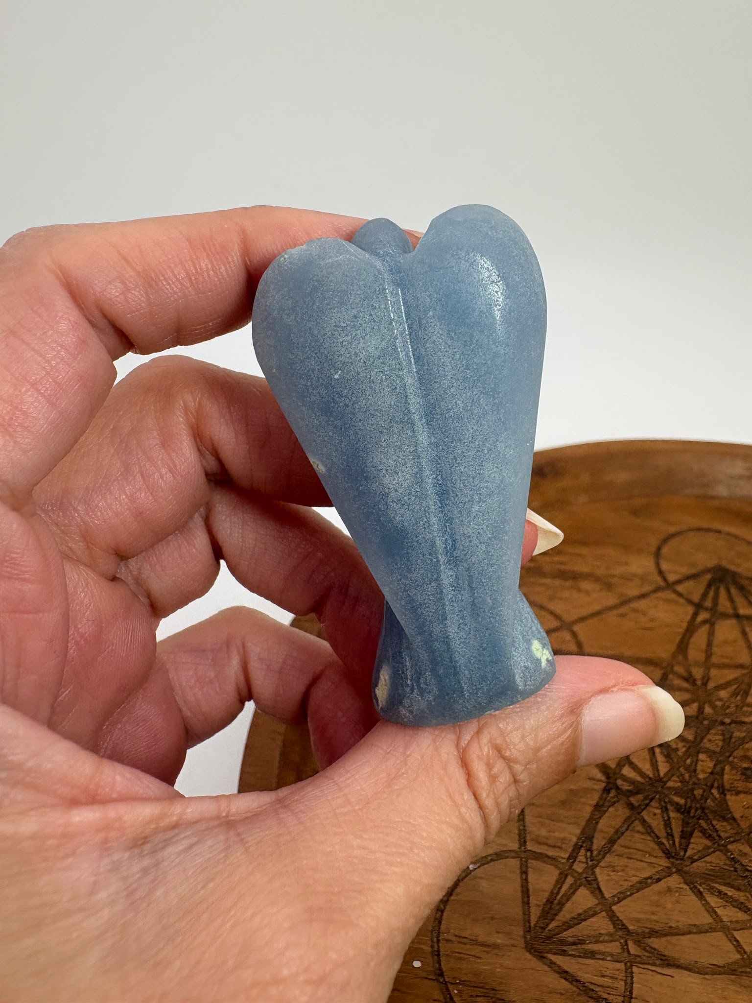 Ángel tallado en angelita natural de 5,3 × 3 cm. Pieza única de suave color azul, ideal para meditación, decoración y colección.