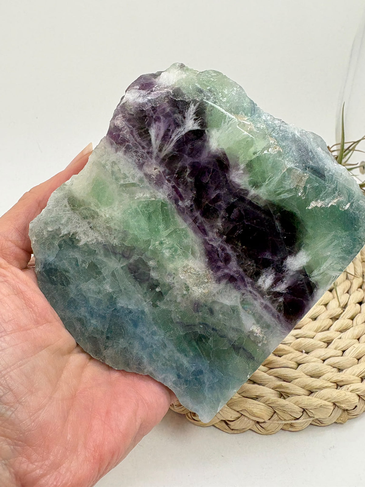 Fluorita arcoíris natural de cara pulida en tonos verdes, azules y violetas.
